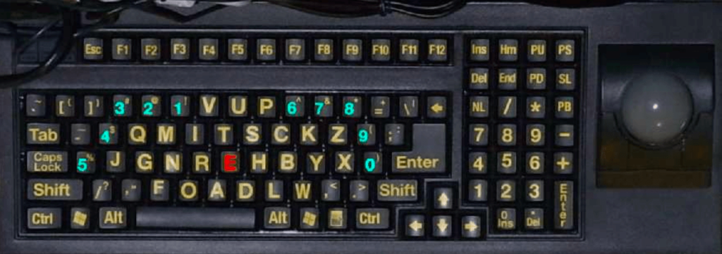 Photo of Dr. Chubon's keyboard. It’s using his layout on a hardware keyboard that has been remapped. The number keys and alpha keys are color-coded.